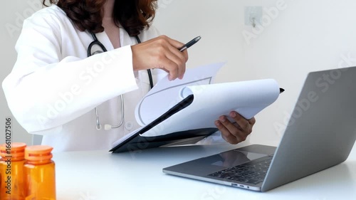 An Asian female doctor made an appointment for a patient to hear the results of the examination and explained the results in detail with the results of the examination and treatment in the hospital.	