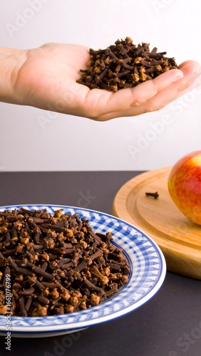 Handful of cloves and plate of cloves