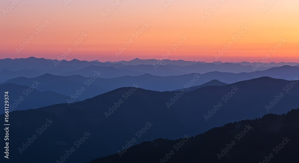 Serene Mountain Peaks Under a Soft Orange and Pink Sunrise Sky Serene Mountain Peaks Under a Soft Orange and Pink Sunrise Sky