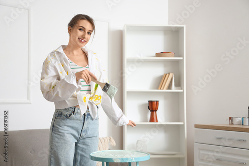 Young woman with brush pain...