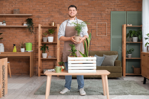 Young male gardener with pl...