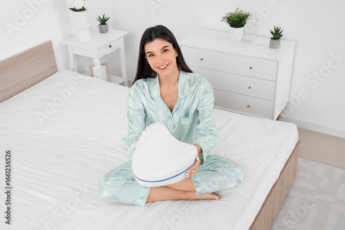 Young woman in pajamas with...