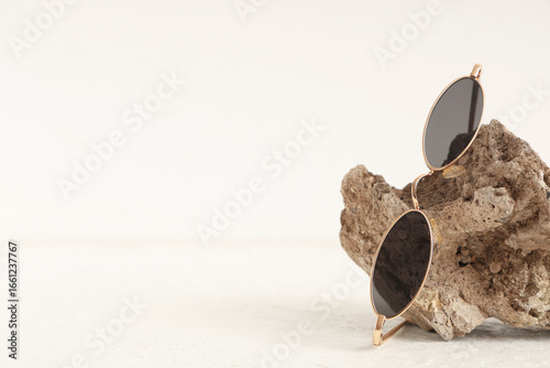 Stylish sunglasses and ston...