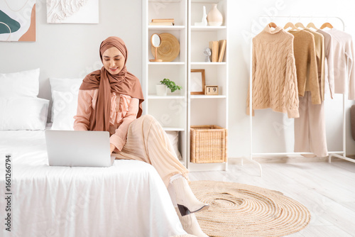 Stylish Muslim woman using ...