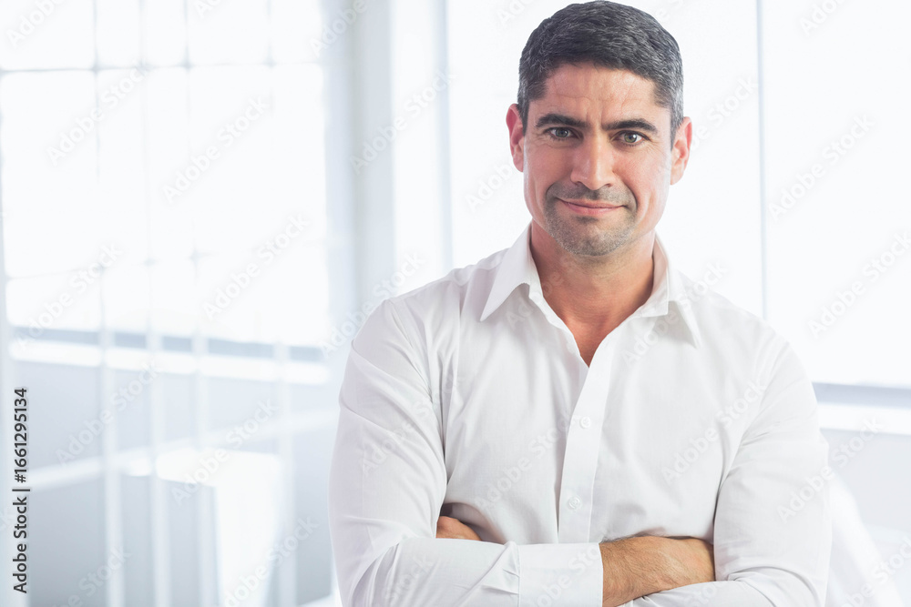 Fototapeta premium Man wearing white shirt looking at camera against frosted grid windows in office, copy space