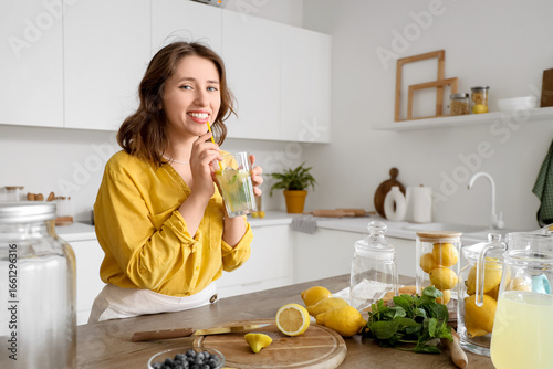 Young woman with tasty lemo...