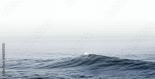 Ocean wave crests in a misty seascape with a soft light.