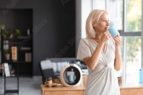 Mature woman drinking coffe...