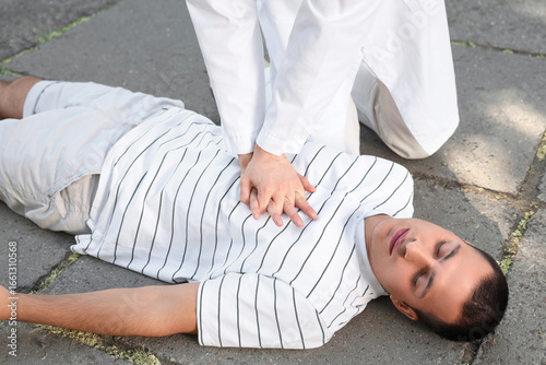 Female doctor doing CPR on ...