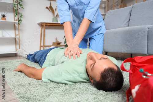 Female doctor doing CPR on ...