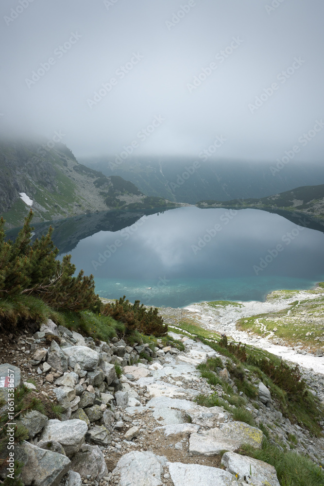 Obraz premium Czarny Staw pod Rysami in the High Tatras. Misty mountain landscape. 