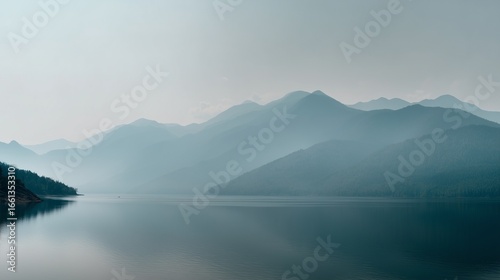 Minimalist landscape with distant low mountain range in soft gray outlines reflected on a calm gray-blue lake, 70% water, thin strip of pale sky, smooth gradients, no elements