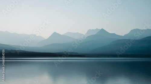 Minimalist landscape with distant low mountain range in soft gray outlines reflected on a calm gray-blue lake, 70% water, thin strip of pale sky, smooth gradients, no elements