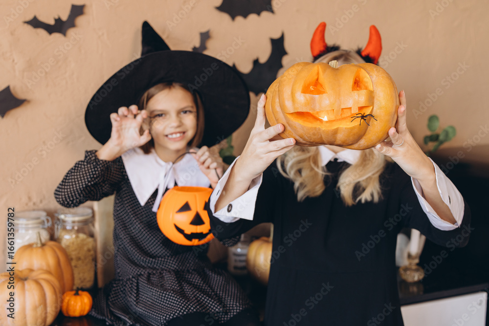 Fototapeta premium Mother and Daughter Celebrating Halloween with Carved Pumpkins