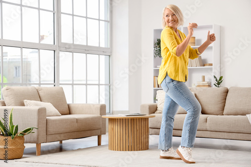 Mature woman dancing at home