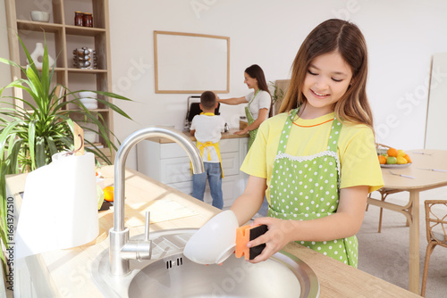 Teenage girl washing dishes...