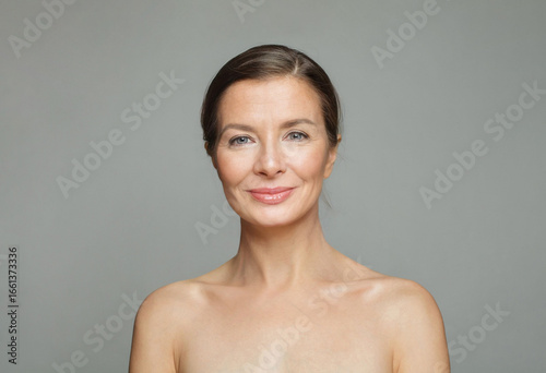 Gorgeous mid aged mature woman looking at camera and smiling. Healthy face skin care beauty