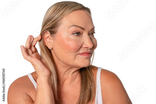 Wallpaper Mural Senior woman showing natural beauty with soft smile while touching her hair on plain background Torontodigital.ca