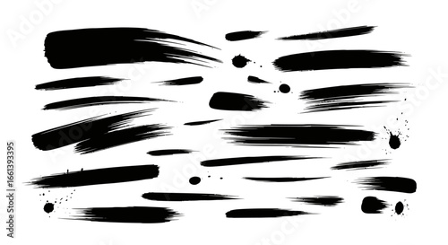Collection of various black paint brushstrokes and splatters on a white background.