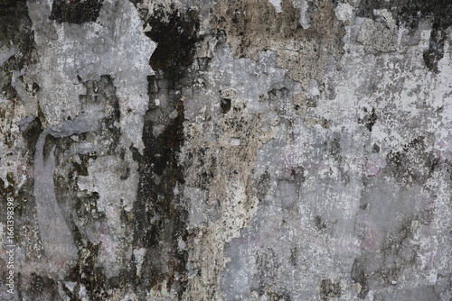 old cement wall with dirty surface and peeling paint texture due to weather exposure. 