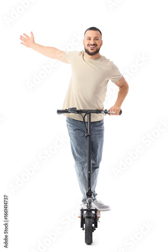 Happy young man riding elec...