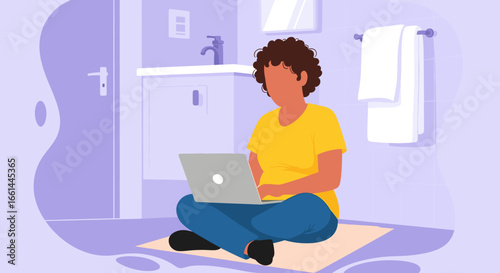 Person focused on remote work, using a laptop while sitting casually on a bathroom floor, illustrating flexible modern work-life balance.