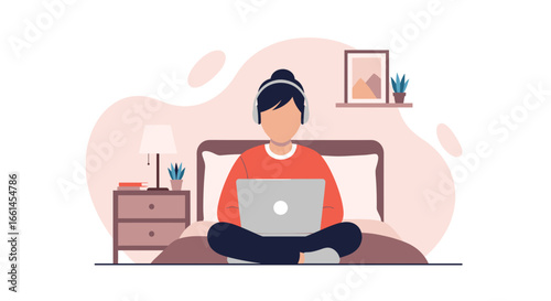 Person working remotely from bed with a laptop and headphones in a cozy bedroom setting. Ideal for remote work, online learning, and digital lifestyle concepts.