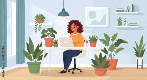 Productive woman working remotely at a desk with a laptop in a vibrant, plant-filled home office, showcasing a modern freelance lifestyle.