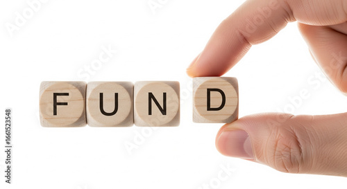 Human hand placing final cube forming FUND finance concept