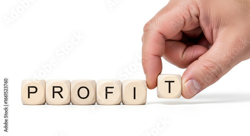 Human hand placing final cube forming PROFIT finance concept