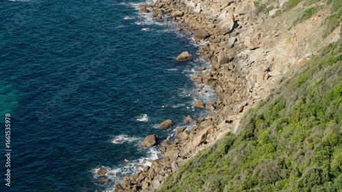 Waves crash over rugged rocks along the Atlantic coastline near Tangier, Morocco.