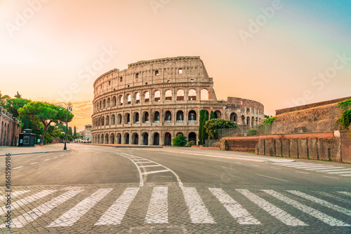 Wall Mural Colosseum exterior view with empty street at sunrise Rome Italy