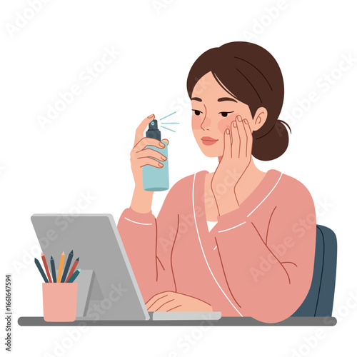 A young woman working remotely at her desk takes a refreshing break, applying a hydrating facial mist to her skin for a quick pick-me-up.