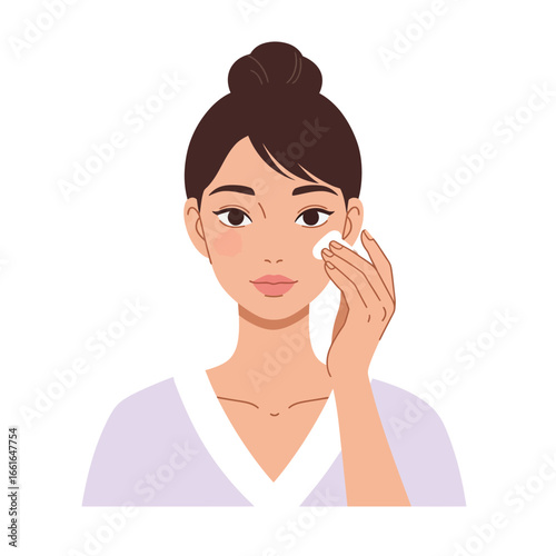 A young woman with a neat bun gently cleanses her face using a soft cotton pad, illustrating a daily skincare routine for healthy, glowing skin.