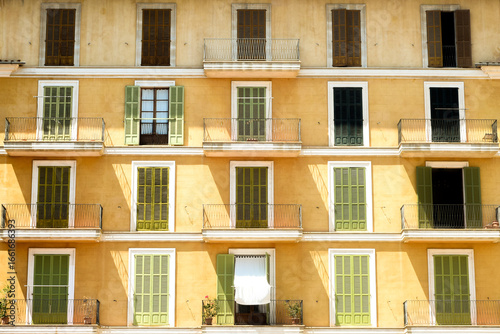 Shuttered windows on the exterior facade of a traditional european apartment building