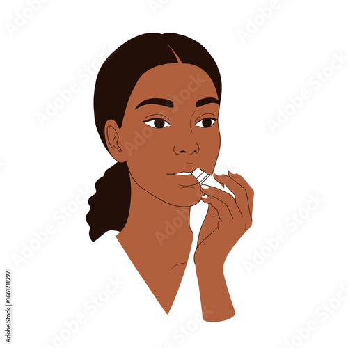 A young, diverse woman with beautiful dark skin applies a protective lip balm, highlighting her daily self-care and beauty routine.