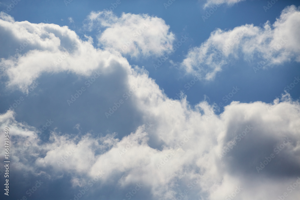 Bright cumulus clouds against a vibrant blue sky create an image of purity, lightness, and tranquility. Bright cumulus clouds against a vibrant blue sky create an image of purity, lightness, and tranquility.