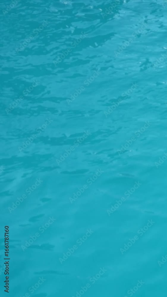 Gentle ripples on turquoise water surface in sunlit pool closeup Gentle ripples on turquoise water surface in sunlit pool closeup