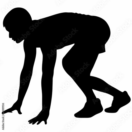 a person in a running start position on a track or field event