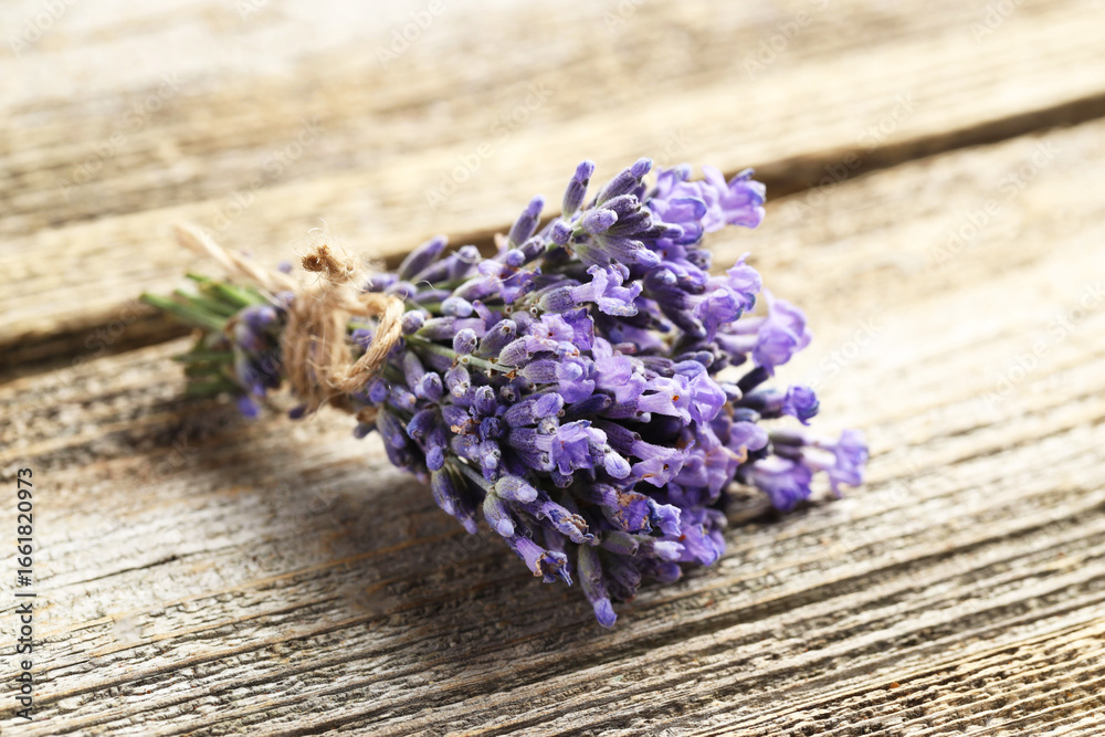 Fototapeta premium Bunch of beautiful lavender flowers on wooden table, closeup