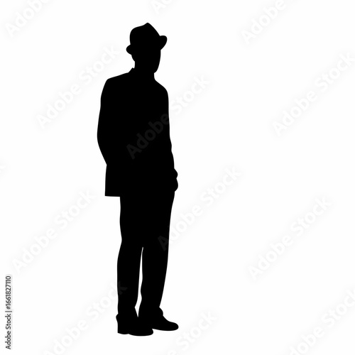 A man in a suit and hat standing with his hands by his sides