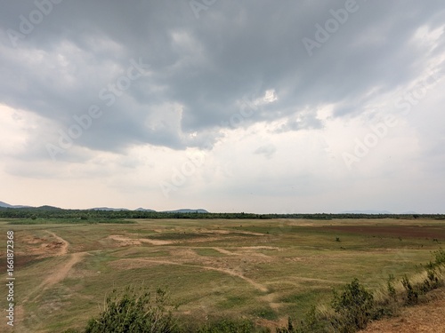 A barren lakebed, cracked and silent under the sun’s gaze.
