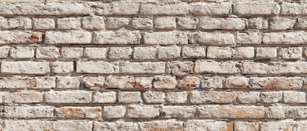 Fototapeta premium The rustic brick wall showcasing a textured and weathered surface.