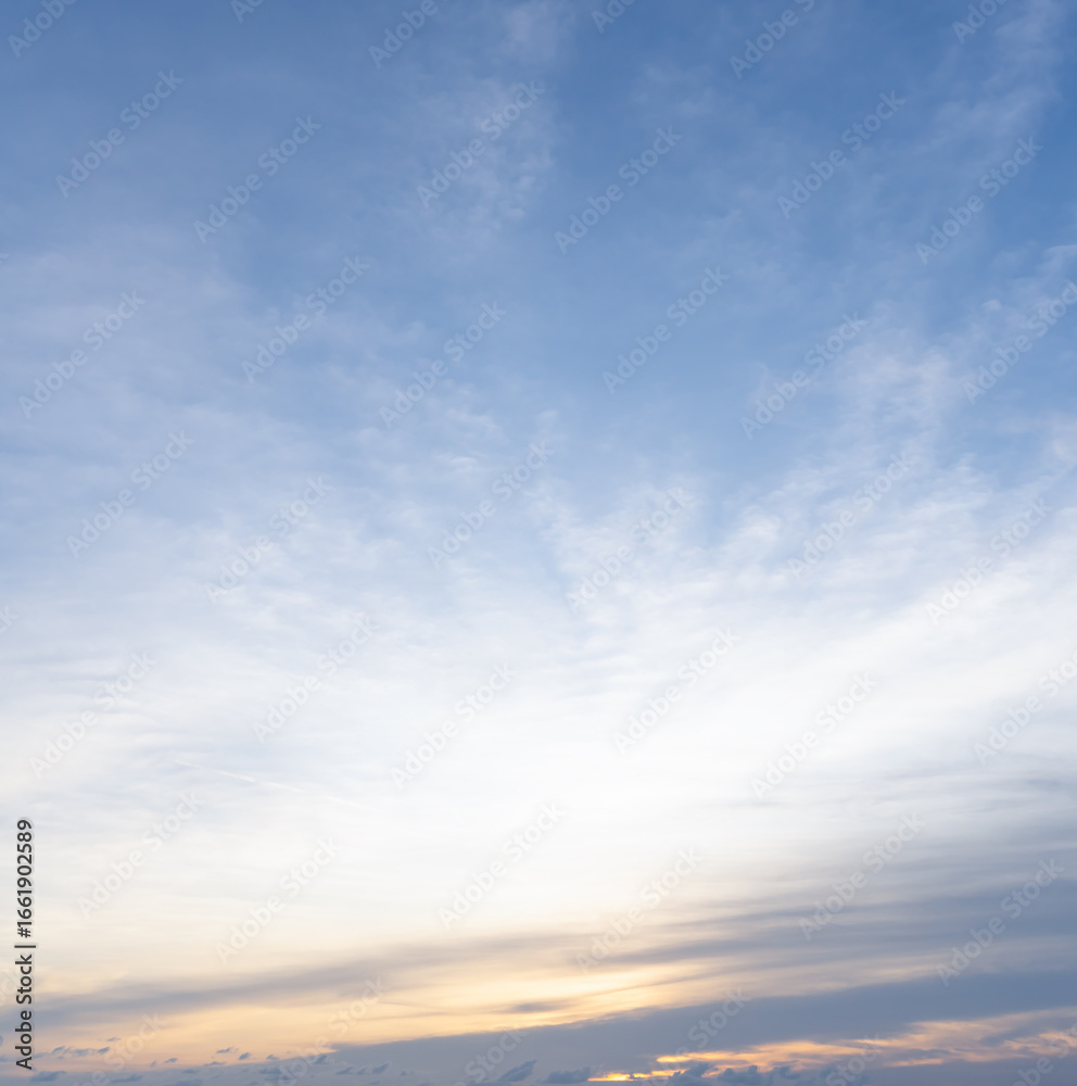 Fototapeta premium Beautiful morning or evening blue and orange sky with cloudy while sunsets or sunrises taken at the sea used as natural background texture