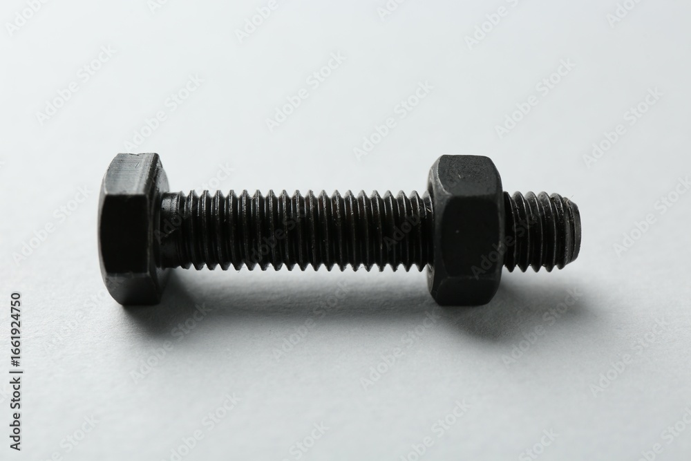 Metal bolt and nut on white background, closeup. Hardware tool Metal bolt and nut on white background, closeup. Hardware tool