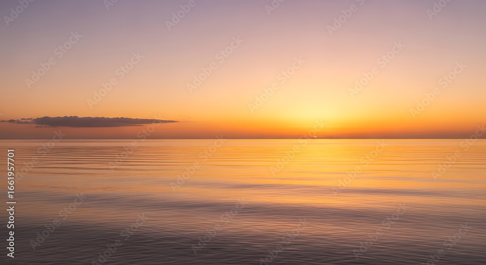 Golden hour sunset over the ocean water with a cloudscape and calm sea for background or wallpaper use Golden hour sunset over the ocean water with a cloudscape and calm sea for background or wallpaper use