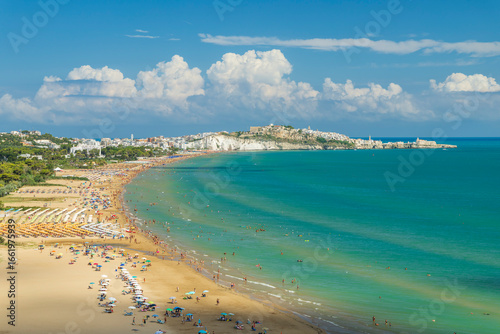 Fototapeta Naklejka Na Ścianę i Meble -  Tourists relaxing on the Pizzomunno Beach in Vieste, Italy