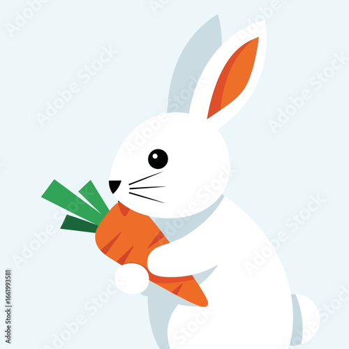 A cute white rabbit with long ears holding and eating a fresh orange carrot with green leaves.