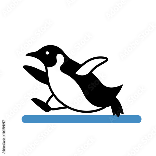 A black and white penguin running across a blue ice floe with its wings outstretched.