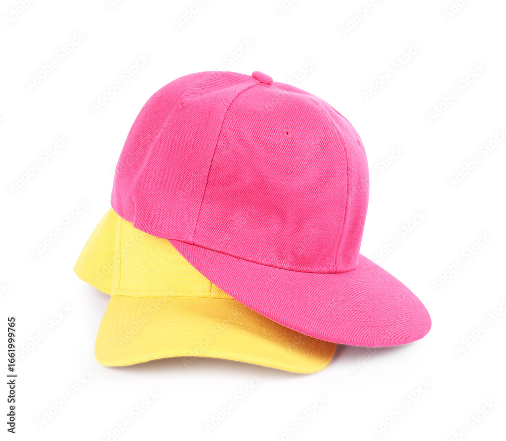 Fototapeta premium Pink and yellow baseball caps isolated on white. Mockup for design